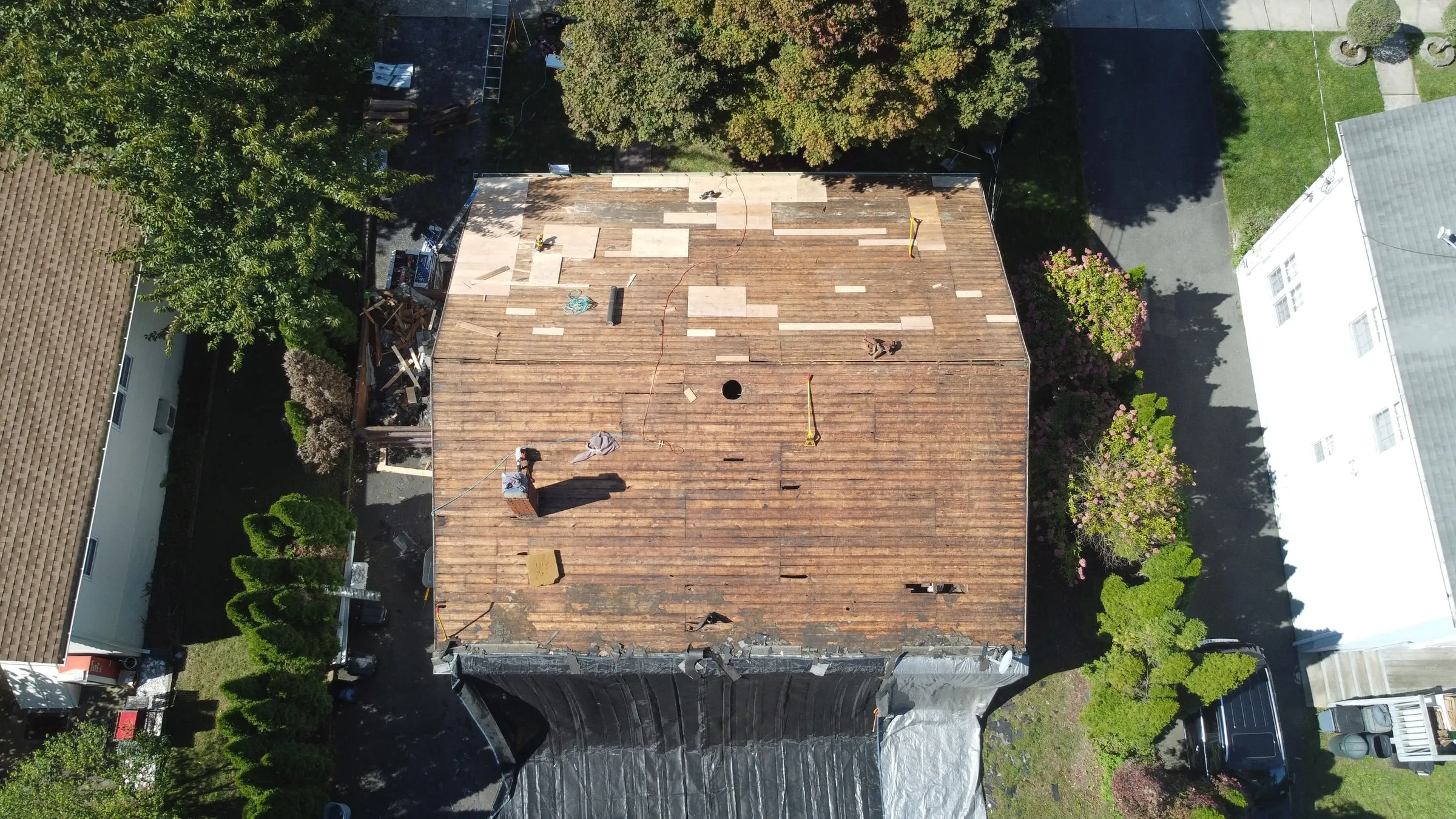 Aerial view of a roof stripped to the deck during a Titan roof replacement