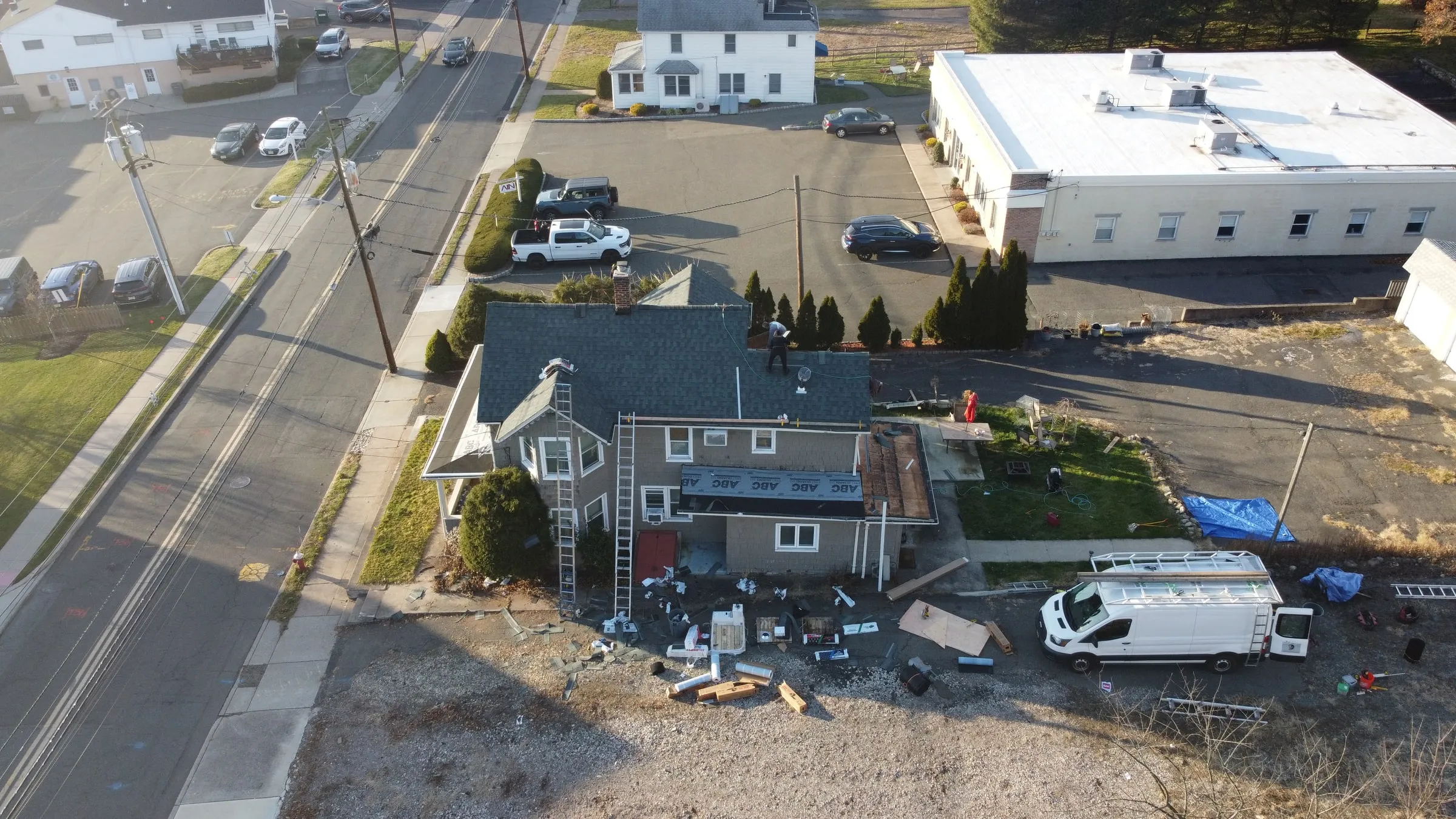 Overhead drone photo of a roofing job site with the Titan van
