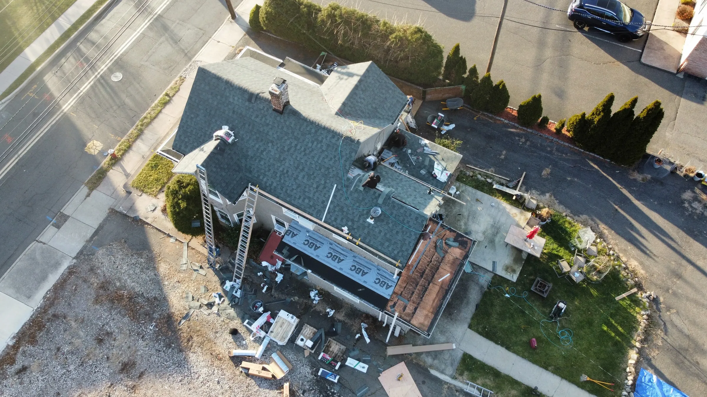 Angled drone shot of a roof replacement on a corner lot